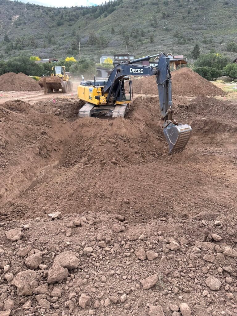 a construction vehicle digging a hole in dirt