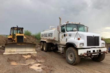 a white truck on a dirt road