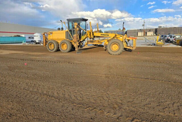 a yellow construction vehicle on a dirt road